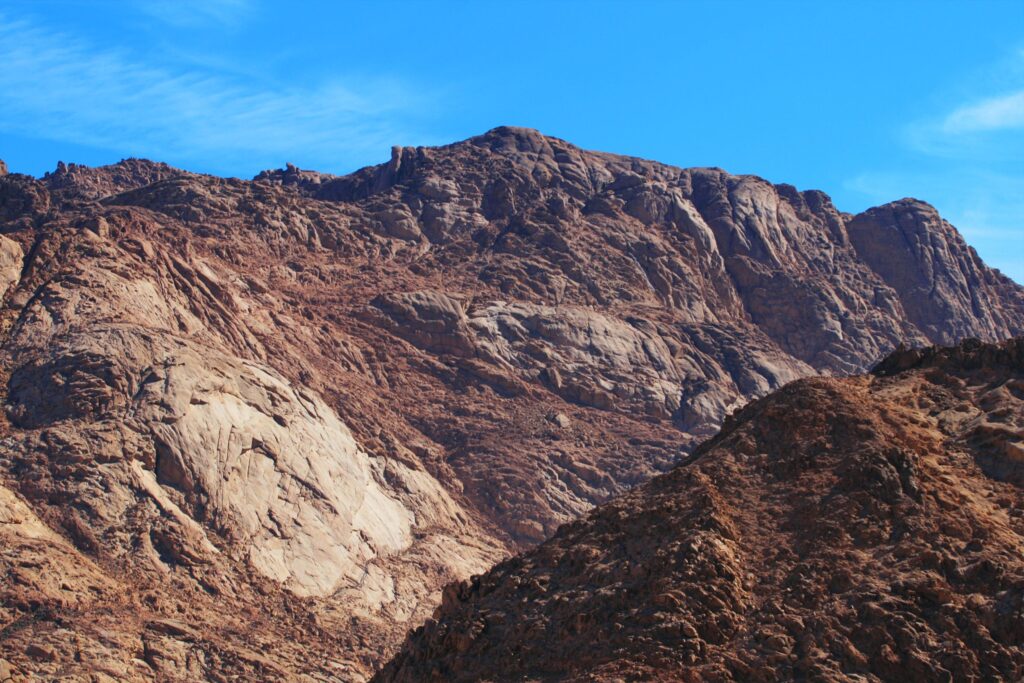 Majestic rocky sinai mountain scene with clear blue sky, perfect for nature lovers and adventurers.